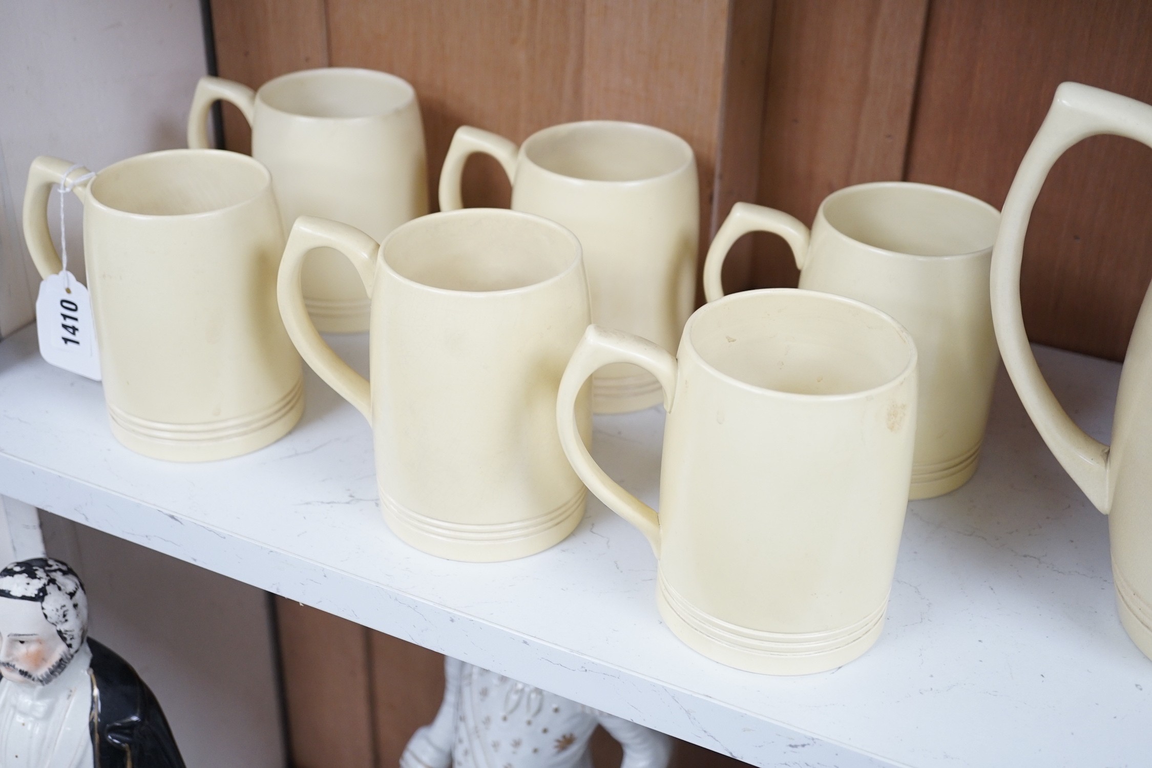 Keith Murray for Wedgwood- a cream-glazed jug and six similar mugs, jug 20.5cms high